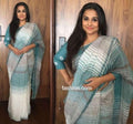 White and light blue colored Partywear Linen Designer Printed Saree